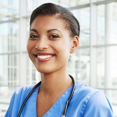 Nurse smiling at acamera